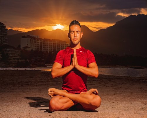 Person doing relaxing yoga at sunrise